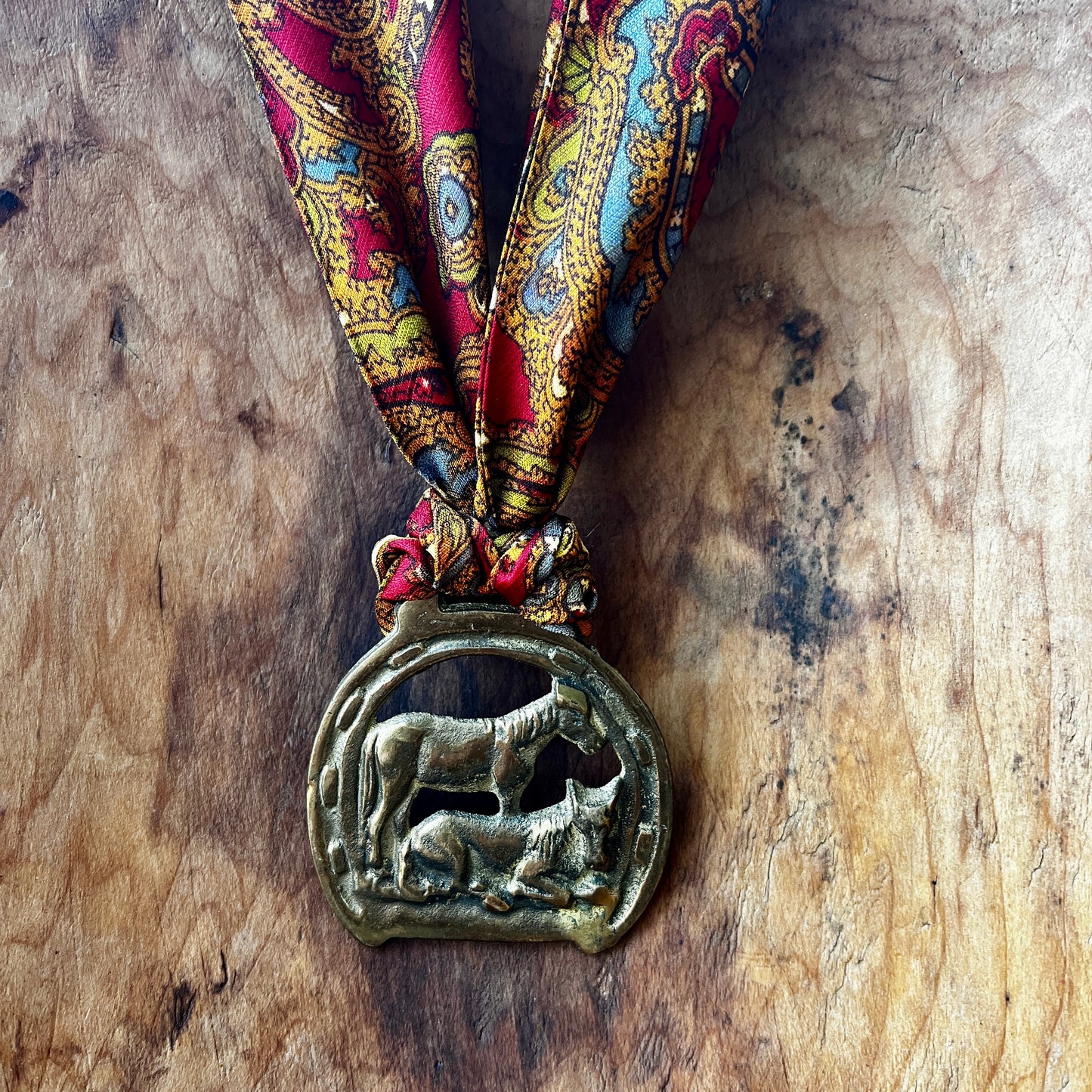 Vintage horse brass medallion necklace with paisley scarf, equestrian boho jewelry.