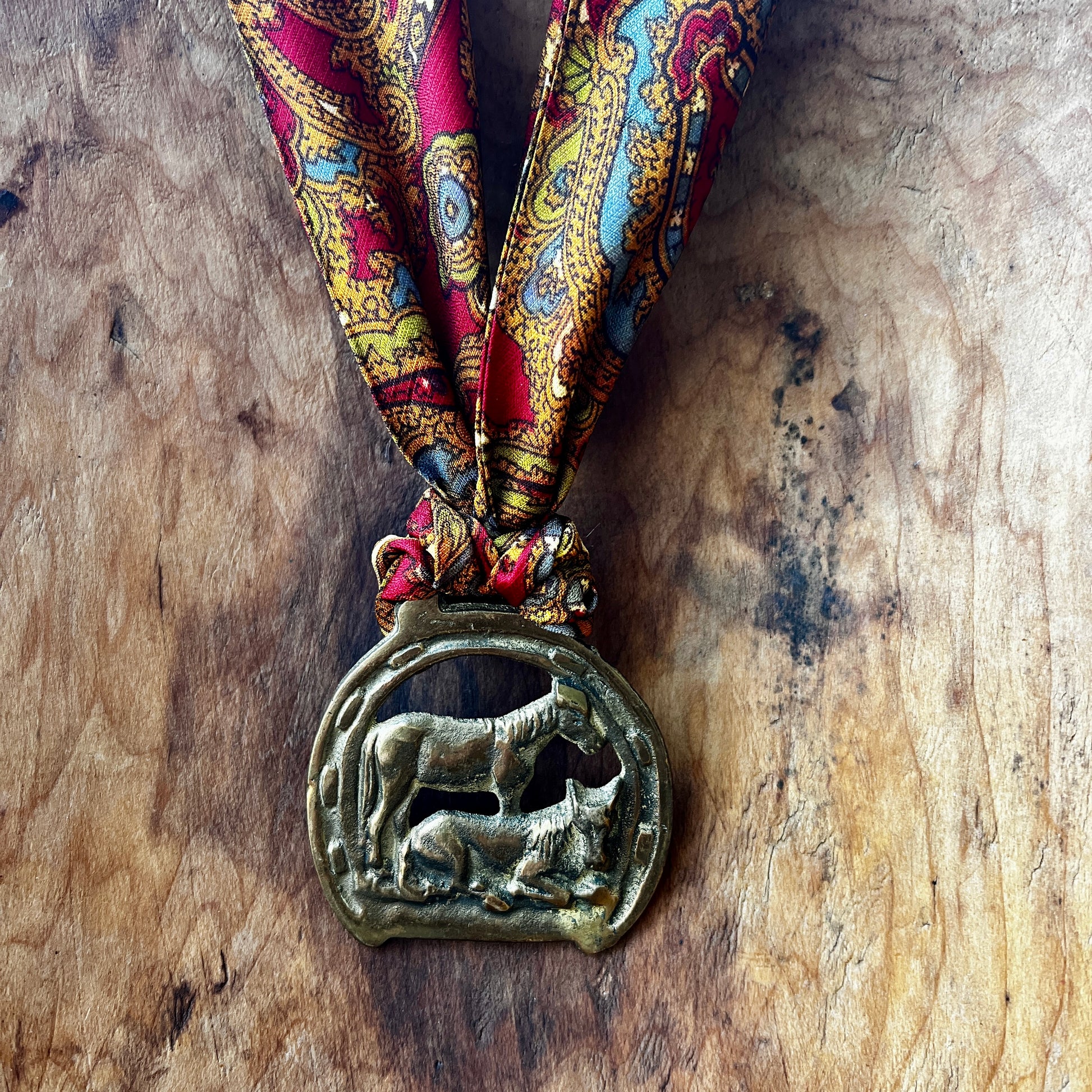 Vintage horse brass medallion necklace with paisley scarf, equestrian boho jewelry.