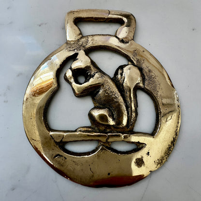 Vintage squirrel brass horse medallion on multi-strand black and silver beaded necklace with leather connector.