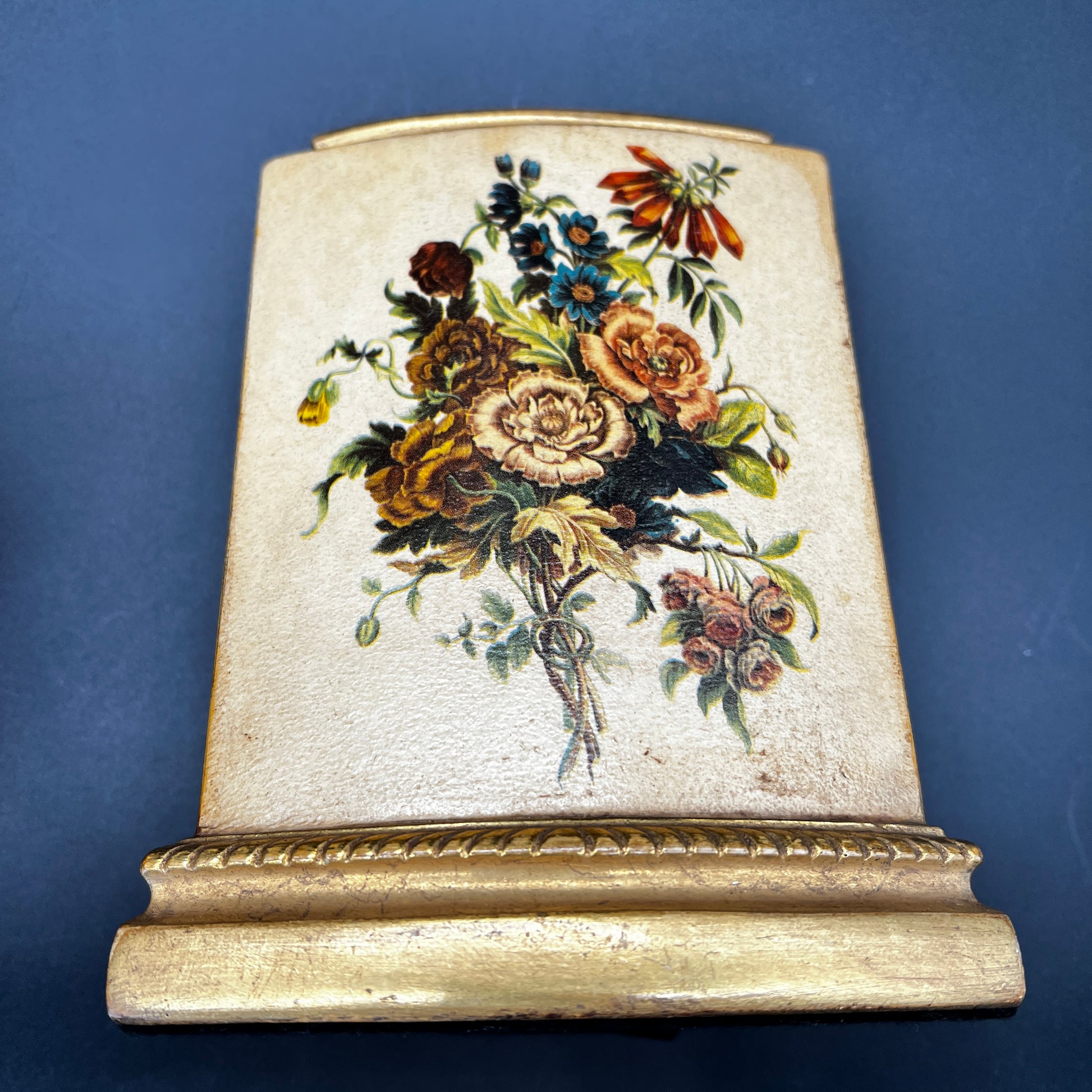 Pair of vintage MCM Borghese floral gold bookends with raised flower design for styled shelves or mid century décor.
