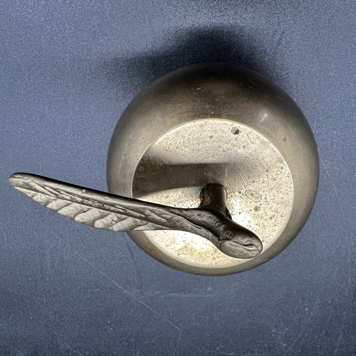 vintage brass apple bell showing patina and stem detail.