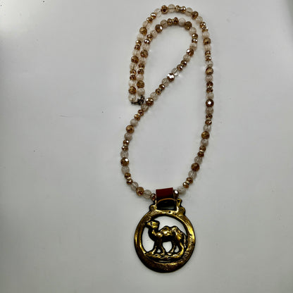Vintage camel horse brass medallion on double-strand neutral beaded necklace with caramel leather connector.