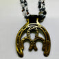 Vintage double horseshoe brass medallion necklace with dark multi-strand beads and leather connector.