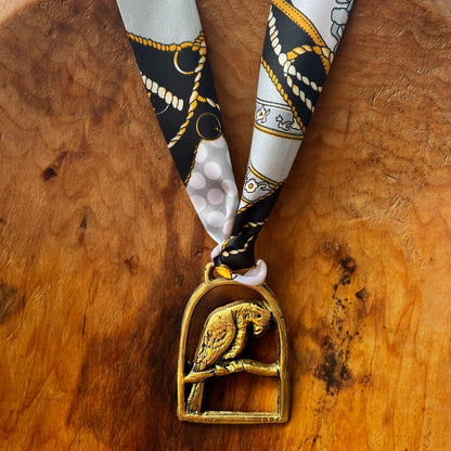 Vintage parrot brass medallion necklace with black and gold scarf, boho eclectic jewelry.