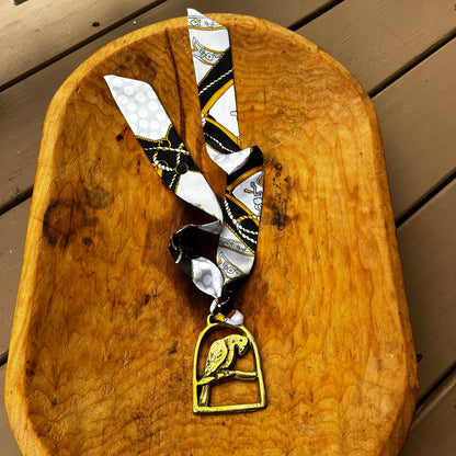 Vintage parrot brass medallion necklace with black and gold scarf, boho eclectic jewelry.