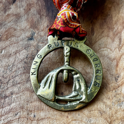 Vintage King Rufus Stirrup brass medallion necklace with red paisley scarf, equestrian jewelry.