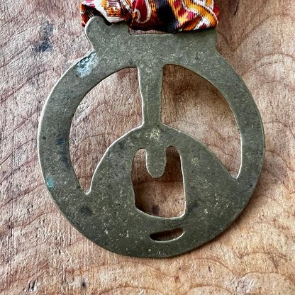 Back of Vintage King Rufus Stirrup brass medallion 