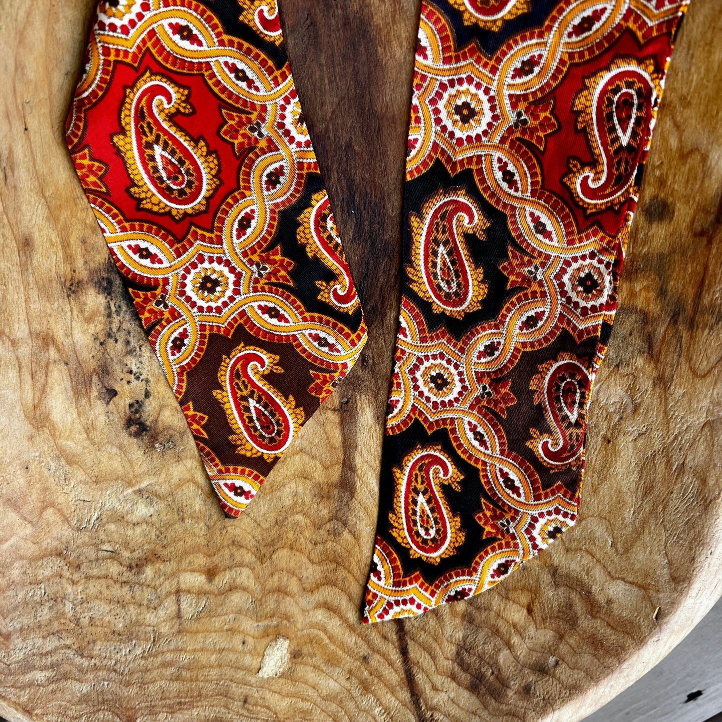 Vintage King Rufus Stirrup brass medallion necklace with red paisley scarf, equestrian jewelry.