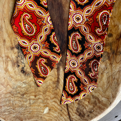 Vintage King Rufus Stirrup brass medallion necklace with red paisley scarf, equestrian jewelry.