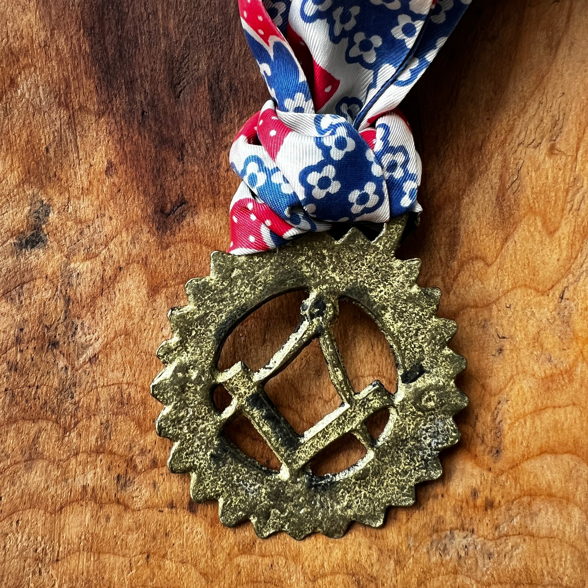 Back of Vintage Masonic square and compass brass medallion necklace with red white blue scarf.