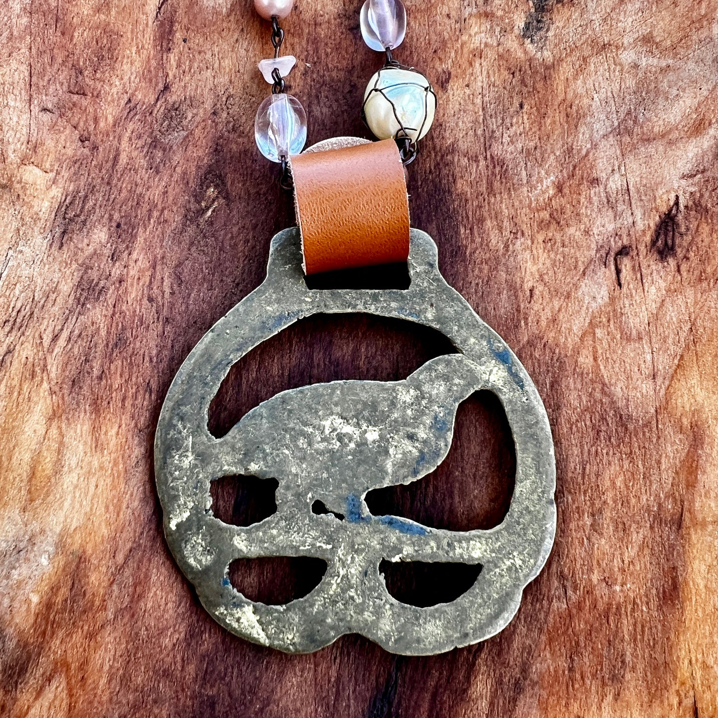 Back of Vintage pheasant brass medallion 