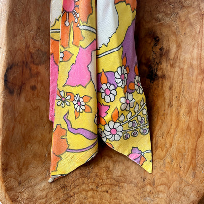 Vintage Red Lion London brass medallion necklace with bright retro floral scarf.