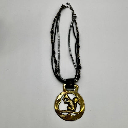 Vintage squirrel brass horse medallion on multi-strand black and silver beaded necklace with leather connector.