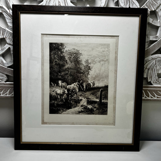Framed black and white print of a pastoral scene with cows and a landscape.