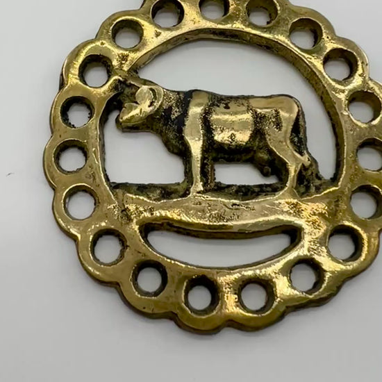 Vintage cow horse brass medallion attached to brown leather keychain with brass hardware.Video 