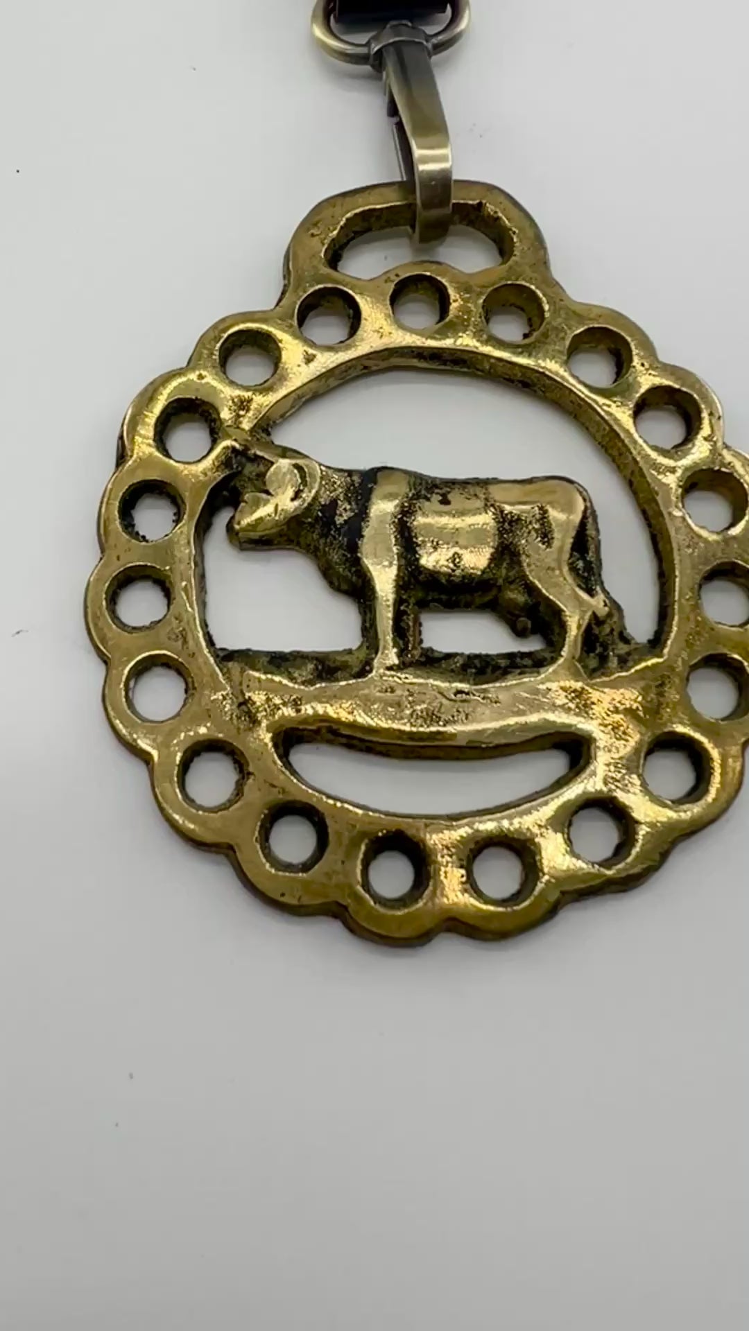 Vintage cow horse brass medallion attached to brown leather keychain with brass hardware.Video 