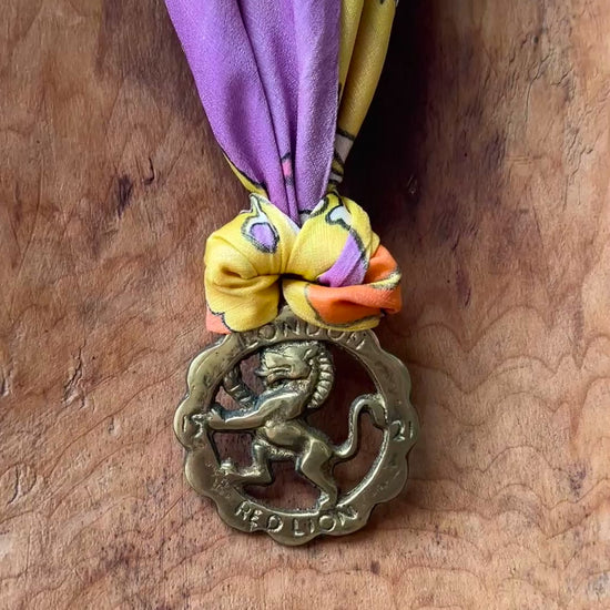 Video of Vintage Red Lion London brass medallion necklace with bright retro floral scarf.