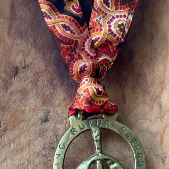 Video Vintage King Rufus Stirrup brass medallion necklace with red paisley scarf, equestrian jewelry.